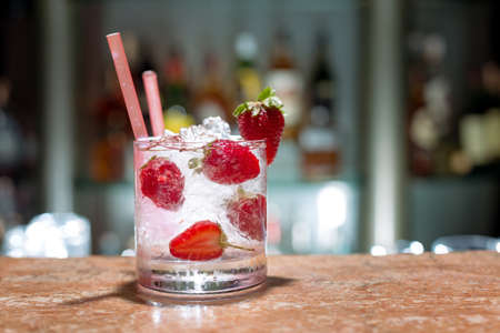 Glass of strawberry mojito on marble tableの写真素材