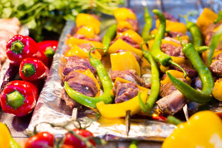 Beef on skewer on a display in an open buffet restaurantの写真素材