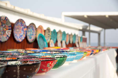 Collection of turkish traditional  handpainted pottery bowls in souvenir shop.  Shallow depth of fieldの写真素材