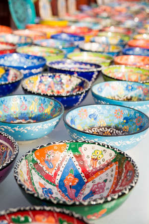 Collection of turkish traditional  handpainted pottery bowls in souvenir shop.  Shallow depth of fieldの写真素材