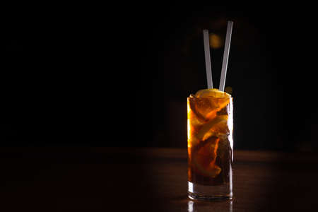Cuba libre cocktail in a tall glass on the dark background. Shallow DOFの写真素材