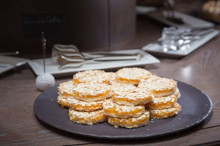 Apricot cookies on wooden table. Shallow DOF and lightly toned.