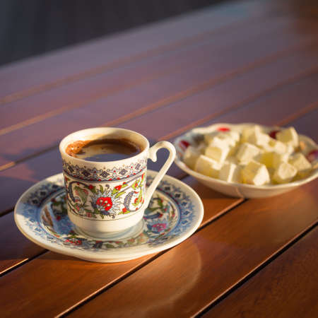 Locum and turkish coffee in outdoor cafe. Direct sunset light. Shallow DOF and lightly tonedの写真素材