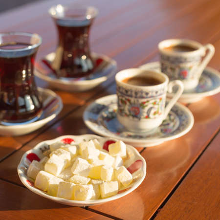 Locum, turkish coffee and turkish tea in outdoor cafe. Direct sunset light. Shallow DOF and lightly tonedの写真素材