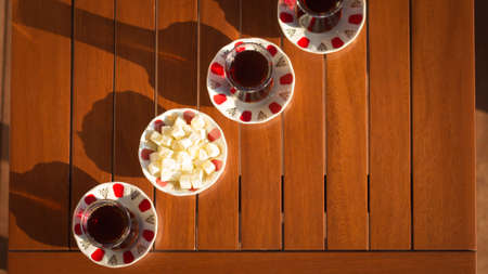 Top view of turkish tea with locum in outdoor cafe. Direct sunset light. Shallow DOF and lightly tonedの写真素材