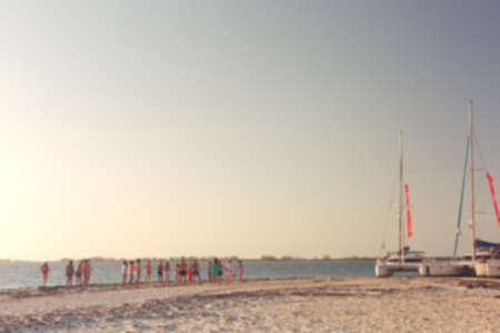 Friends having fun at the beach. Abstract blur background with bokehの写真素材