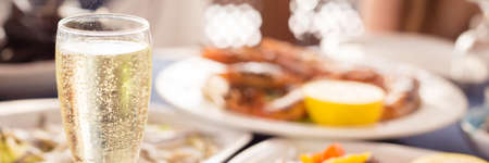 Italian cuisine. Glass of prosecco and variety of seafood. Shallow DOF, bannerの写真素材