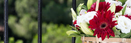 Flower basket on a glass table. Outdoor. Romantic surprise. Horizontalの写真素材