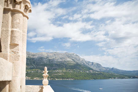 General view from bell tower of Sveti Marko cathedral, Korcula Old Town, Croatia. Architectural detail. Scenic landscape of medieval town and sea. Tourist destination in Europe. Horizontalの写真素材