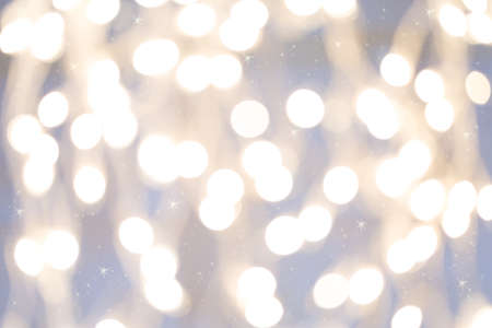Holiday background with white blurred defocused bokeh. With smal stars. Christmas background. Horizontal. Grey toneの写真素材
