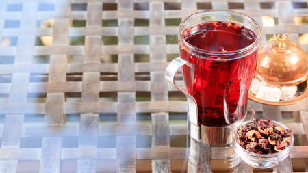 Concept of herbal tea. Hibiscus tea in a glass mug with turkish locum. Healthy caffein-free drink. Neutral background. Horizontal, wide screen formatの写真素材