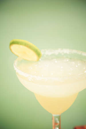 Margarita cocktail on the wooden pier. Concept of classic drink. Vacation background. Vertical, tone applied, close up. Shallow DOFの写真素材
