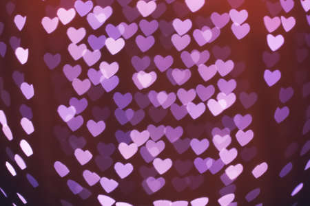 Heart shaped holiday blurred bokeh background. Valentine background. Christmas background. Horizontal.の写真素材