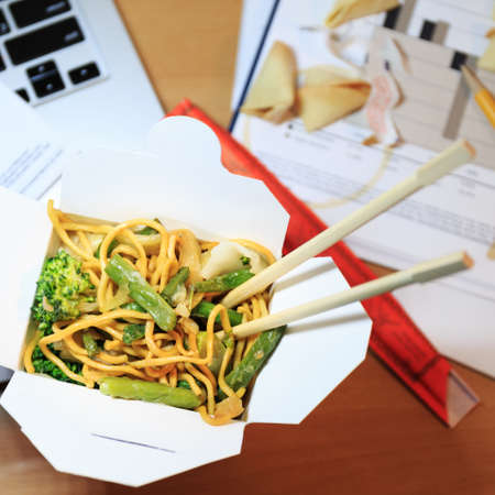 Chinese food box on the office desk. Eating at the office. Overtime work concept. Top view. Squareの写真素材