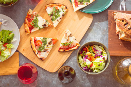 Concept of friendly family dinner party preparation. Warm light, shallow depth of field. Top view. Horizontalの写真素材
