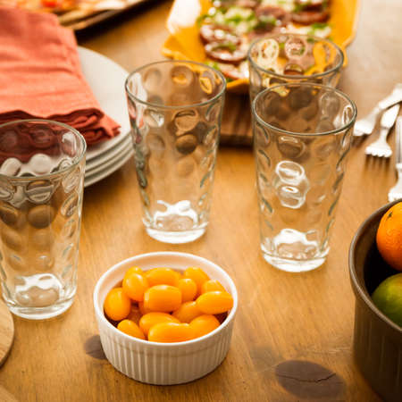 Concept of friendly family dinner party preparation. Warm light, shallow depth of field. Squareの写真素材