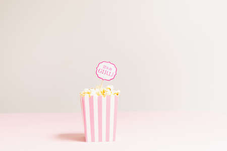 It's a girl sign in a popcorn bag at the baby shower party.  Empty background. Baby shower celebration concept. Festive party background. Horizontalの写真素材