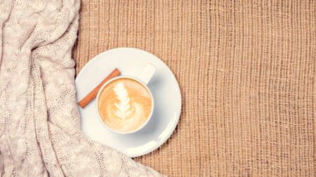 Cup of coffee or chai tea with latte art. Leasure time concept. Pastel colors, warm toning. Horizontal, wide screen formatの写真素材