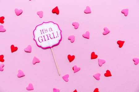 It's a girl sign at the baby shower party.  Pink solid background. Baby shower celebration concept. Minimalistic party background. Flat lay, horizontalの写真素材