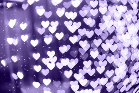 Heart shaped holiday blurred bokeh background with sparkles. Valentine background. Christmas...