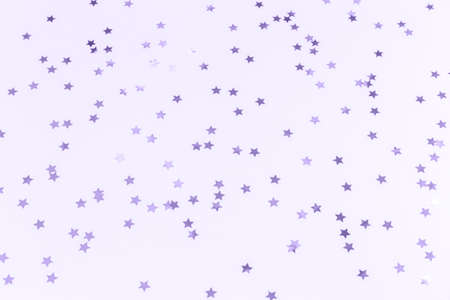 Golden star sprinkles. Festive holiday background. Celebration concept. Top view, flat lay....