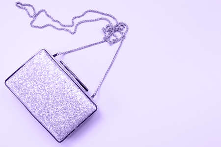 Festive evening golden clutch on pink. Holiday and celebration background. Luxury accessories and party concept. Horizontal. Ultra violet tone, color of the year 2018の写真素材