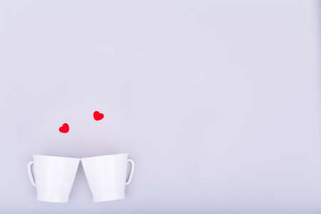 White china mug with  glitter heart confetti. Valentine day concept. Trendy minimalistic flat lay design background. Horizontalの写真素材