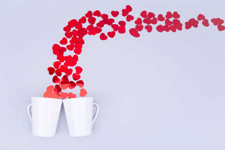 White china mug with  glitter heart confetti. Valentine day concept. Trendy minimalistic flat lay design background. Horizontalの写真素材