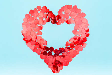 Heart shaped glitter confetti. Valentine day concept. Trendy minimalistic flat lay design...