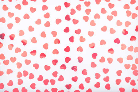 Background with glitter heart confetti. Valentine day concept. Trendy minimalistic flat lay design...