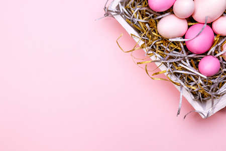 Eggs in a white tray. Creative Easter concept. Modern solid pink background. Horizontalの写真素材