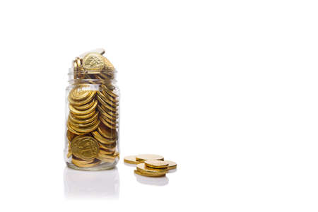 Glass jar with a lot of  gold coins. Good level  of savings.  Savings and wealth management concept...