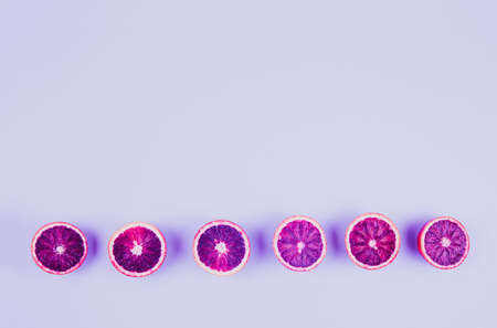 Red oranges on the bold blue background. Creative minimalism and modern food pattern concept....