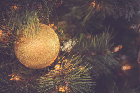 Seasonal background with Christmas toy on the tree. Celebration concept. Soft focus. Horizontal, toned imageの写真素材