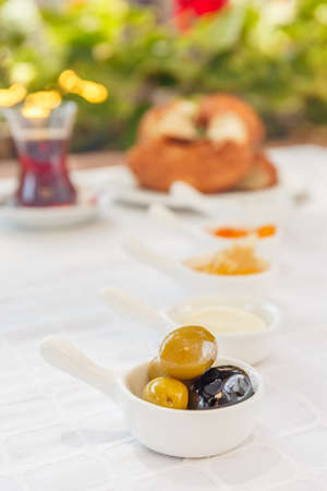 Turkish tea, Honey, Jam,  Olives. Authentic turkish breakfast. Local cuisine concept. Soft focus....