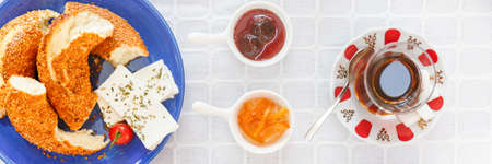 Turkish tea, Cheese, Honey, Jam, Simit.  Authentic turkish breakfast. Local cuisine concept. Soft focus. Horizontal, wide format, bannerの写真素材
