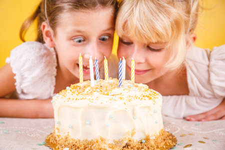 Girls excited by birthday cake. Birthday party celebration concept. Horizontalの写真素材