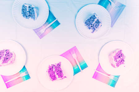 Flat lay with birthday cake pieces on white paper plates. Birthday party celebration concept....