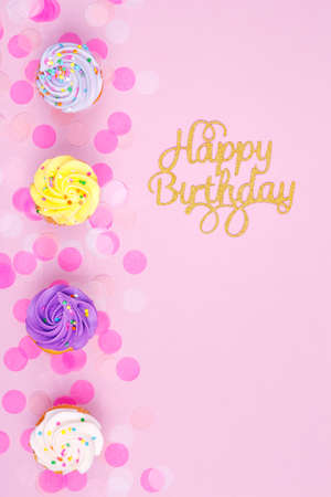 Creative pastel fantasy holiday card with cupcake and happy birthday lettering. Baby shower, birthday, celebration concept. Verticalの写真素材