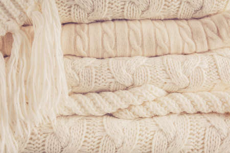 White knits pile. Warm cozy home concept. Horizontal, warm toningの写真素材