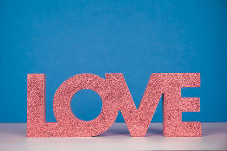 Red sign LOVE. Valentine day concept. Trendy minimalistic holiday design background. Soft focus. Horizontal, surreal toned imageの写真素材