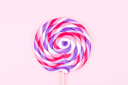 Big lollipop on solid pink background. Horizontalの写真素材