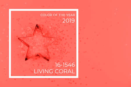 Flatlay with star cookie cutter and snowflake sprinkles on blue background. Holiday, Christmas and New Year concept. Cozy homey details. Horizontal. Living coral theme - color of the year 2019の写真素材