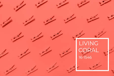 Pink clothes pins on the pink background. Horizontal. Living coral theme - color of the year 2019