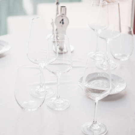 Wine and water glasses at the restaurant table. Upscale restaurant concept. Squareの写真素材