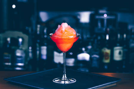 Cocktail at a nightclub. Nightlife and entertainment concept. Horizontal, moody blue toningの写真素材