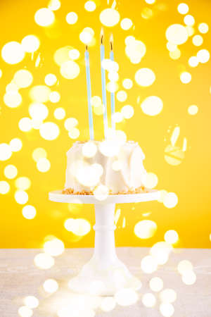 Birthday cake with candles. Birthday party celebration concept. Vertical, bold yellow background,...