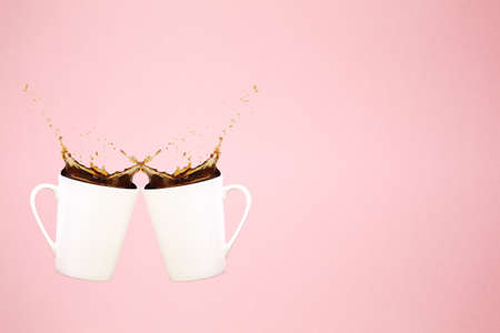 Two levitating coffee mugs with splashes and heart confetti. Coffee concept. Minimal art trend. Solid background. Horizontalの写真素材