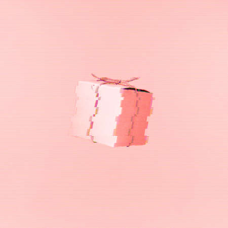 Seemless pattern of craft  cardboard gift boxes on the solid pink background. Holiday and gift concept. Pop art slyle. Square. Glitch effect, colorful disruptive. Living coral - color of the year 2019の写真素材