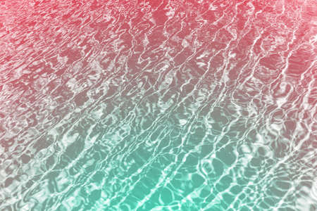 Surface of blue shining swimming pool water ripple. Can be used as background. Futuristic duotone toning to green and redの写真素材